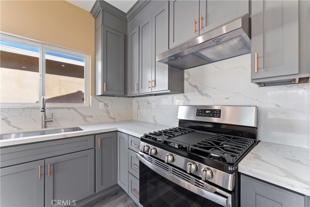 6942 Valmont Street Tujunga, CA 91042 - Photo 9 of 22 a stove top oven sitting inside of a kitchen