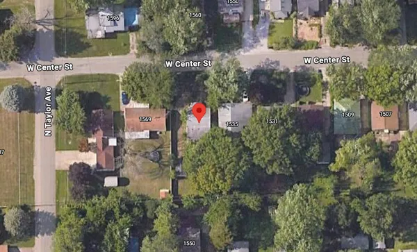 an aerial view of a building with outdoor space and street view