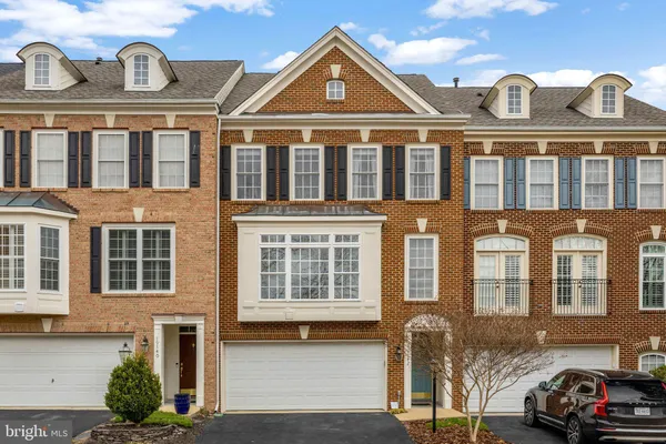 a front view of a residential apartment building with a yard