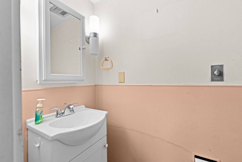 89 Ripley Road Cohasset, MA 02025 - Photo 14 of 23 a bathroom with a sink and a mirror