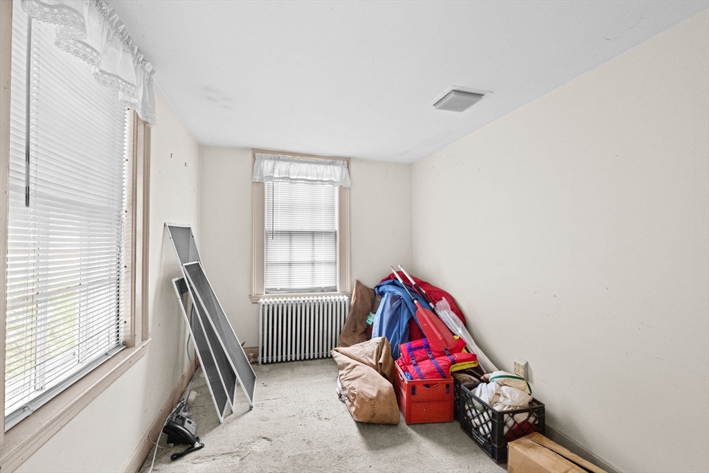 89 Ripley Road Cohasset, MA 02025 - Photo 10 of 23 a living room with a baby crib furniture and a window
