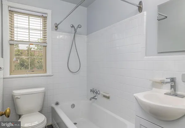 a bathroom with a toilet sink and shower