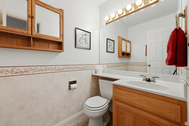 3766 Cardiff Circle Bountiful, UT 84010 - Photo 34 of 46 Bathroom featuring a single vanity with a white countertop and integrated sink, a full-width mirror, and a wall-mounted light fixture with five bulbs