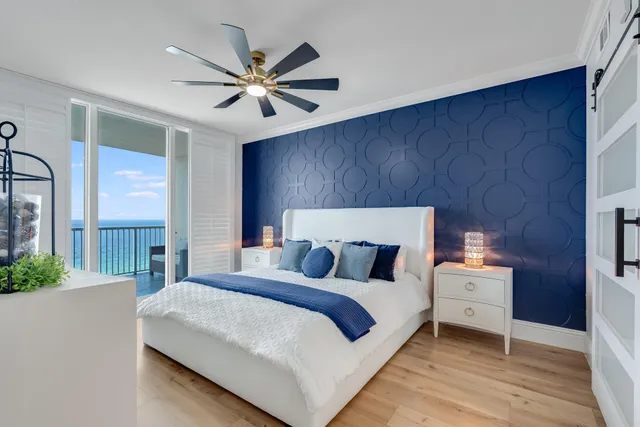 a bedroom with a bed and a ceiling fan
