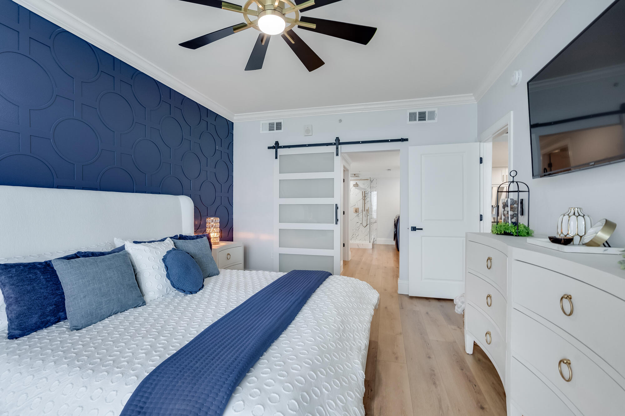 17281 Front Beach Road, Unit 802 Panama City Beach, FL 32413 - Photo 22 of 57 a bedroom with a bed and a chandelier