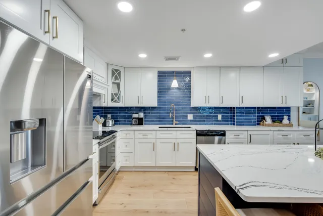 a kitchen with a refrigerator sink and cabinets