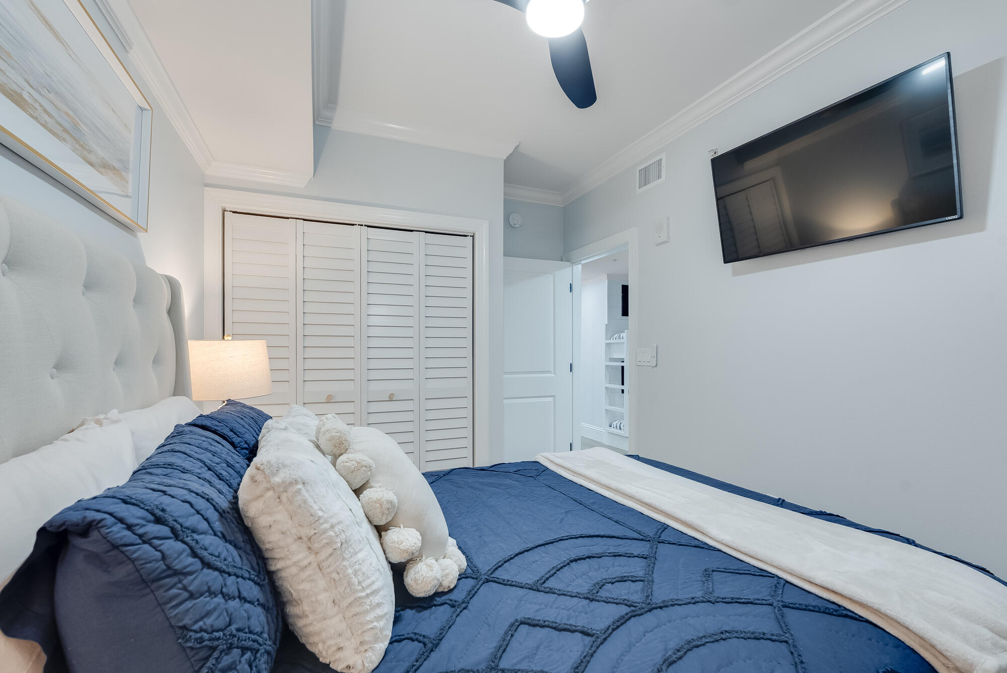 17281 Front Beach Road, Unit 802 Panama City Beach, FL 32413 - Photo 36 of 57 a bedroom with a bed and a flat screen tv