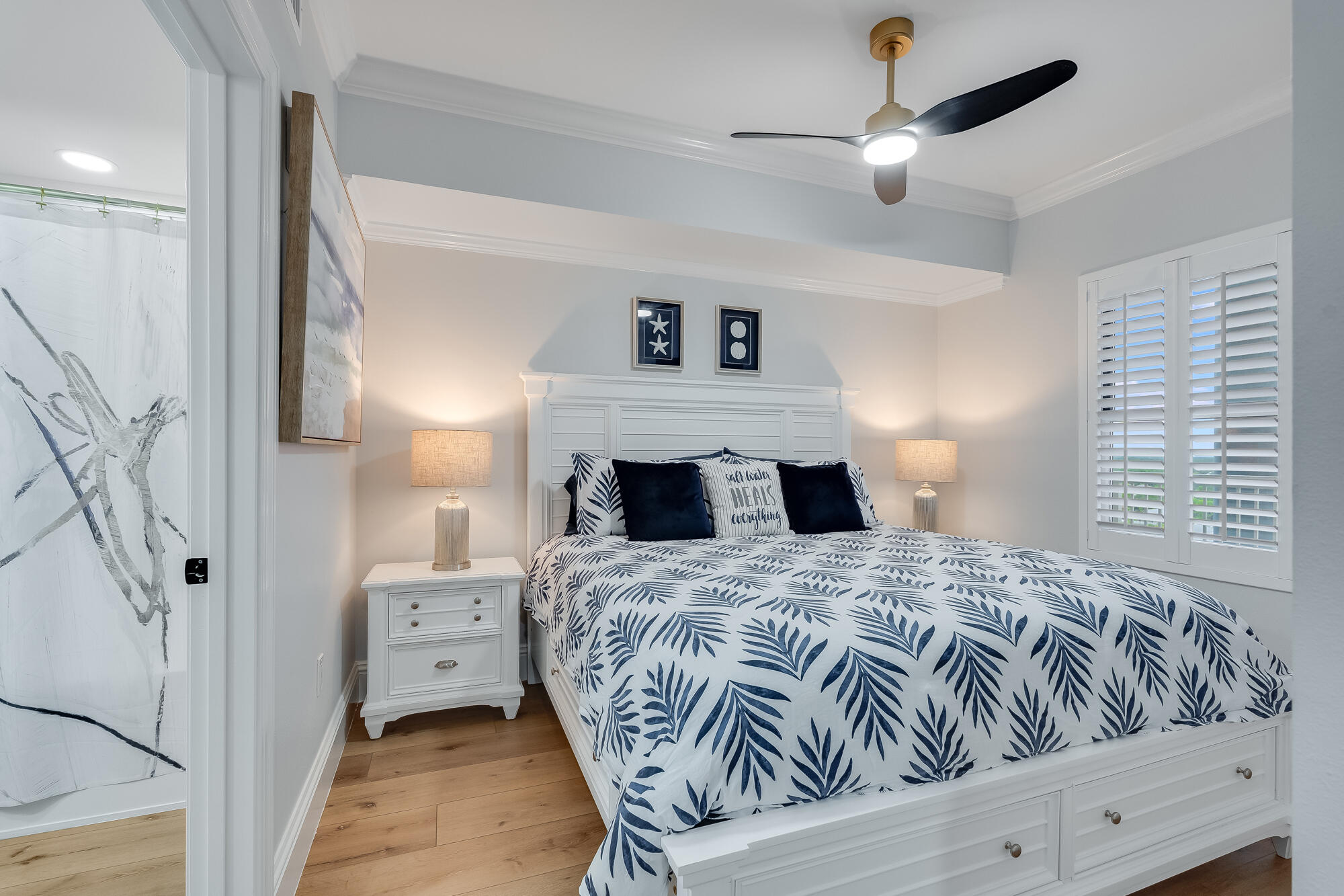 17281 Front Beach Road, Unit 802 Panama City Beach, FL 32413 - Photo 37 of 57 a bedroom with a bed and wooden floor