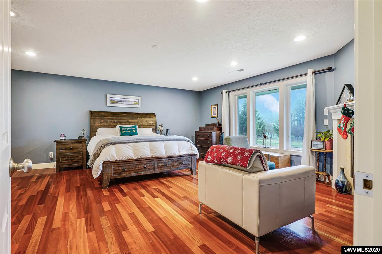 2065 Southeast Godsey Road Dallas, OR 97338 - Photo 20 of 34 a bedroom with a bed and wooden floor