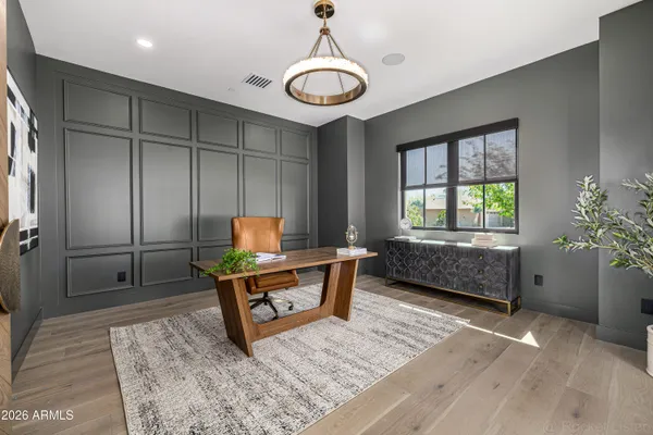 a view of a livingroom with wooden floor and a ceiling fan