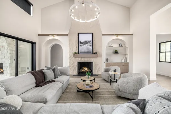 a view of a livingroom with a fireplace wooden floor and front door