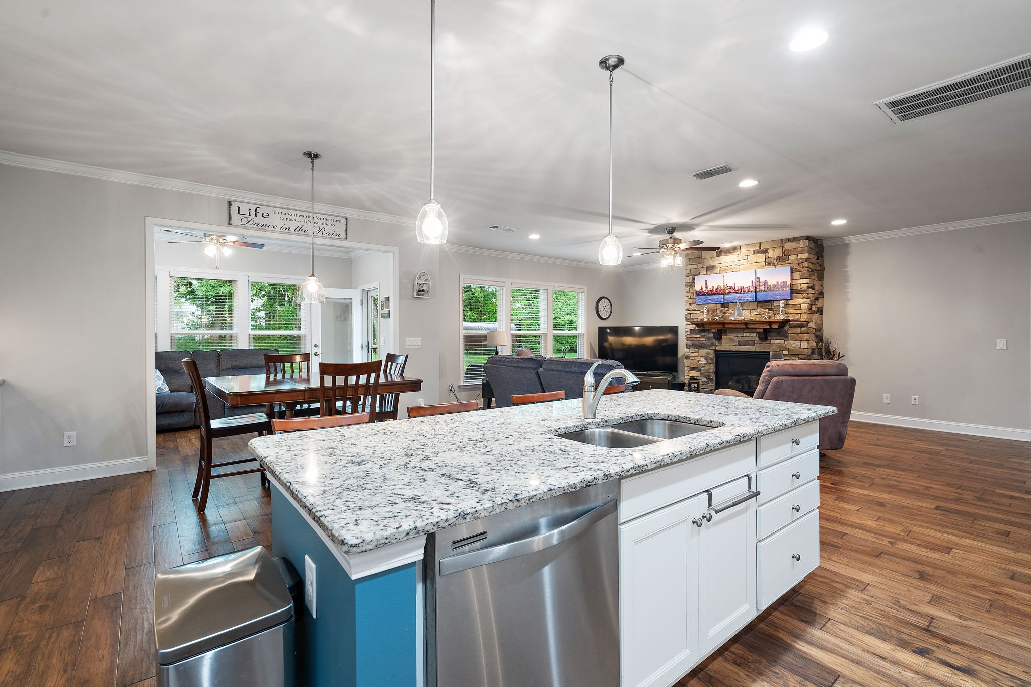 4012 Compass Pointe Court Thompson's Station, TN 37179 - Photo 13 of 54 a kitchen with granite countertop a sink a counter top space and living room view