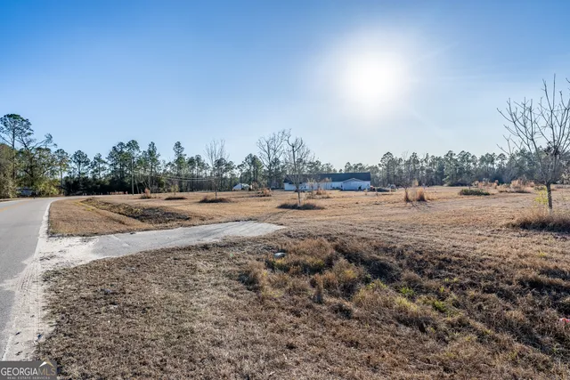 a view of dirt field with trees