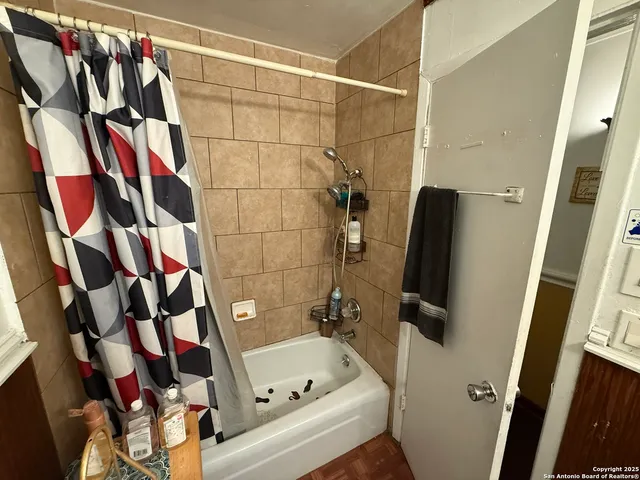 a bathroom with a bathtub and a shower