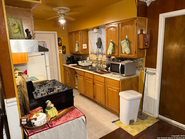 a kitchen with a sink stove and refrigerator