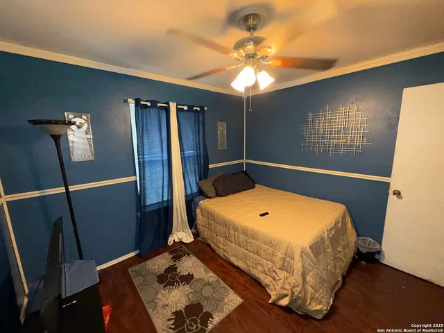 a bedroom with a bed and a chandelier