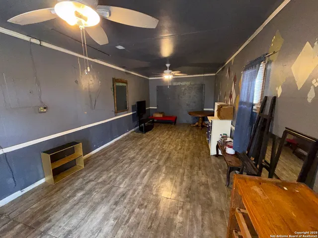 a room with wooden floor and furniture