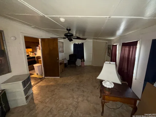 a view of a livingroom with furniture and a fan