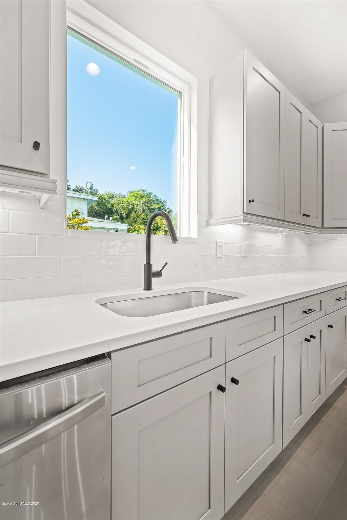 2138 Country Club Road Melbourne, FL 32901 - Photo 16 of 92 a sink with white cabinets