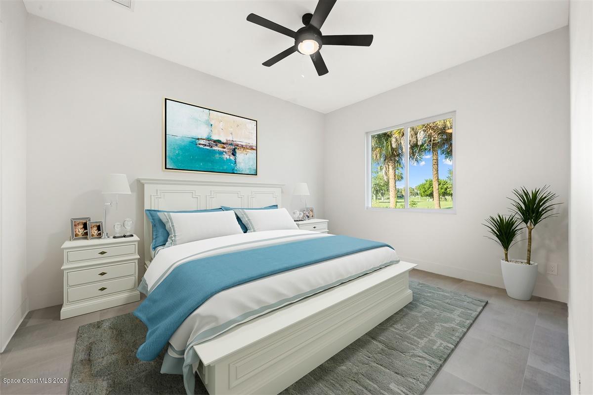 2138 Country Club Road Melbourne, FL 32901 - Photo 25 of 92 a bedroom with a bed and a painting on the wall