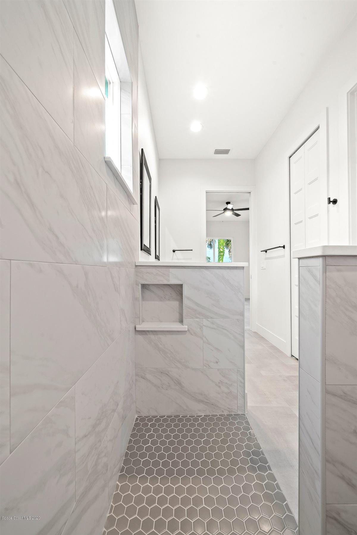 2138 Country Club Road Melbourne, FL 32901 - Photo 33 of 92 a bathroom with a bathtub and a shower