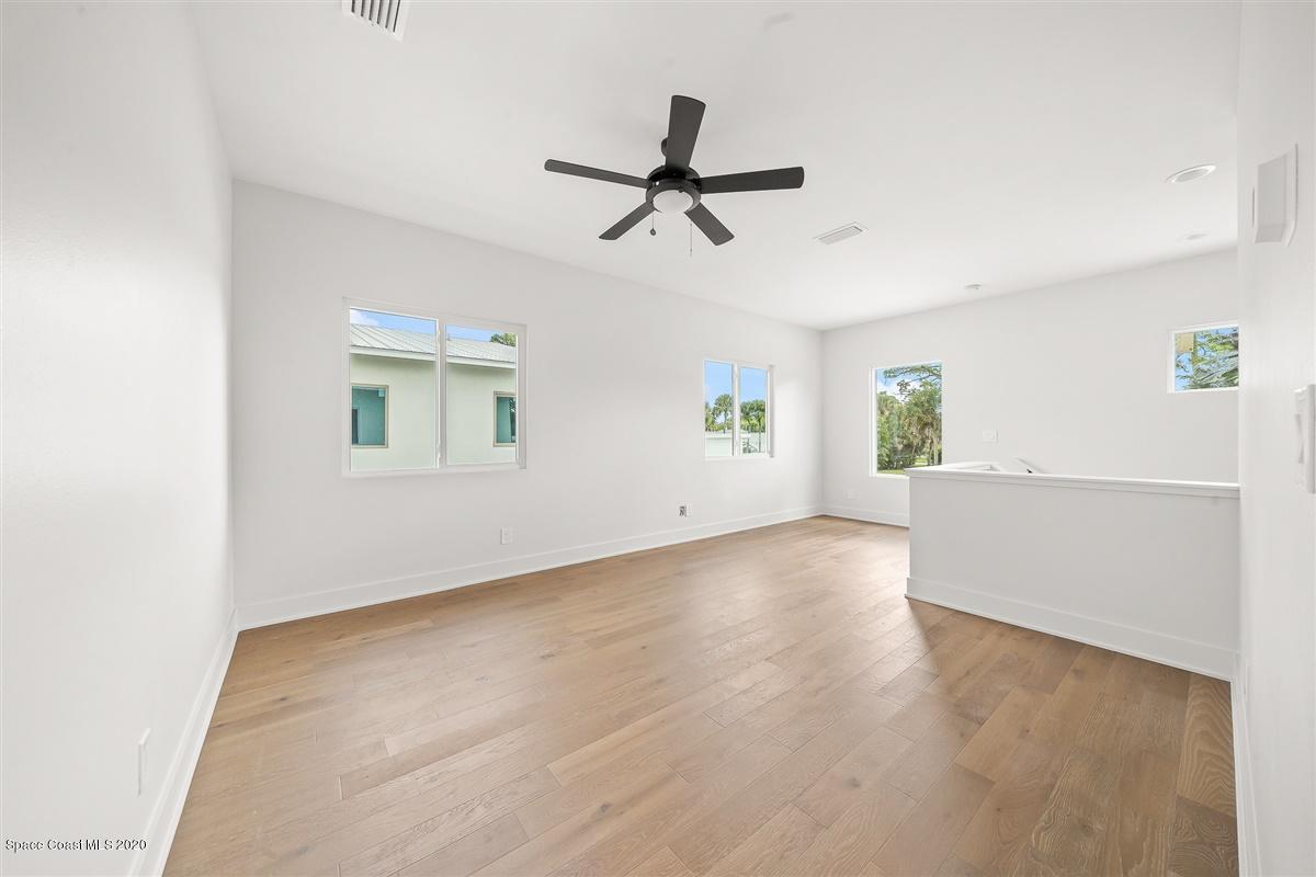 2138 Country Club Road Melbourne, FL 32901 - Photo 40 of 92 wooden floor in an empty room with a window