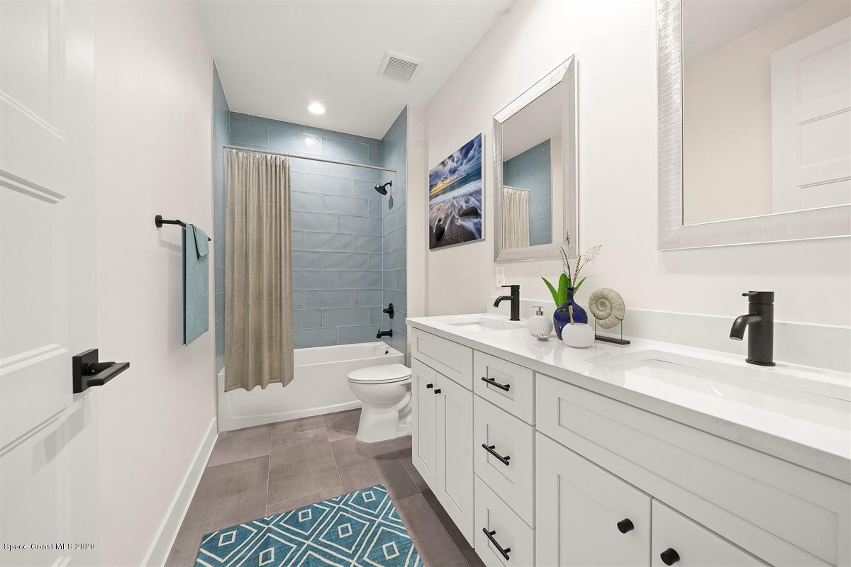 2138 Country Club Road Melbourne, FL 32901 - Photo 48 of 92 a spacious bathroom with a double vanity sink toilet and shower