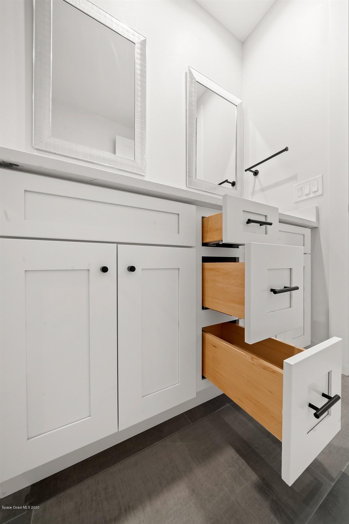 2138 Country Club Road Melbourne, FL 32901 - Photo 55 of 92 a kitchen with white cabinets and white appliances