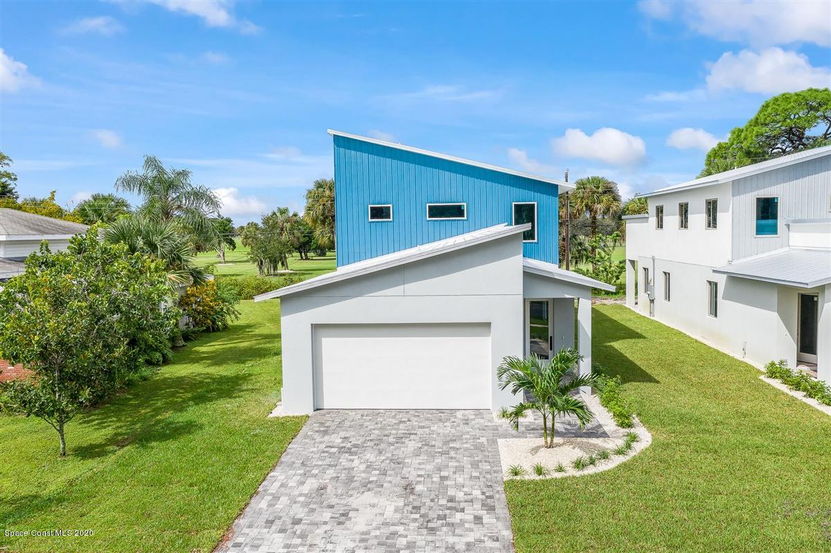 2138 Country Club Road Melbourne, FL 32901 - Photo 64 of 92 a front view of a house with a yard and garage
