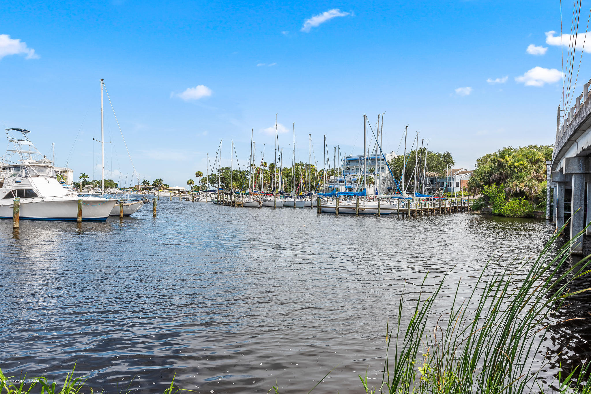 2138 Country Club Road Melbourne, FL 32901 - Photo 76 of 92 a view of a lake with boats and palm trees