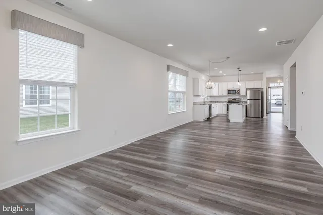 a living room with furniture and a large window with outer view