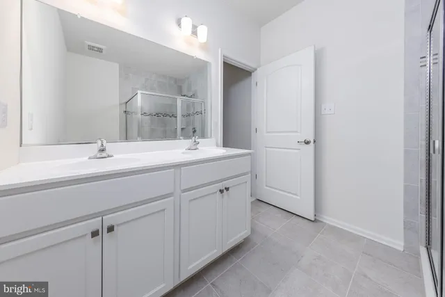 a bathroom with a shower and a sink