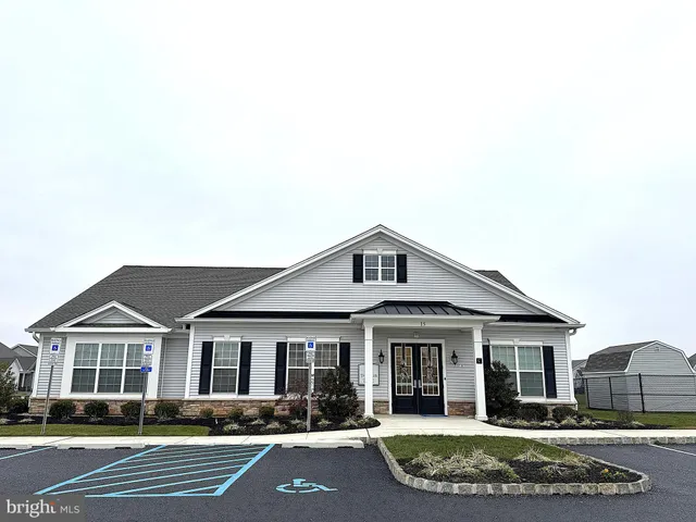 a living room with furniture a table and kitchen view
