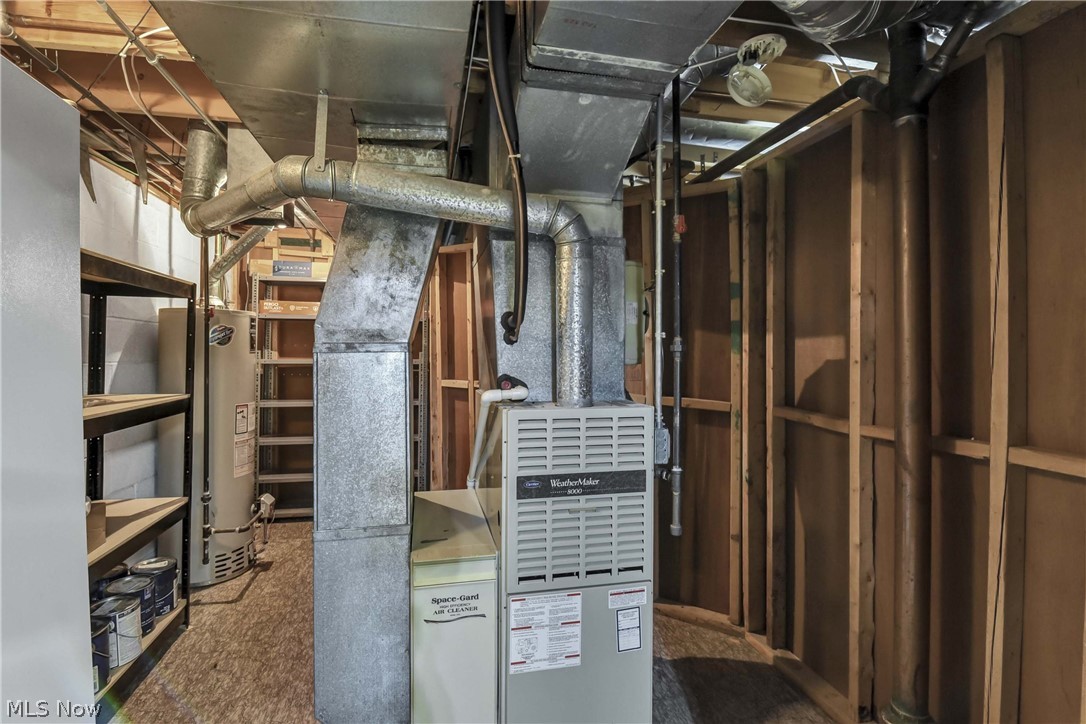 7350 Ames Road Parma, OH 44130 - Photo 32 of 50 Basement Utility room with shelving, freezer, furnace and hwt