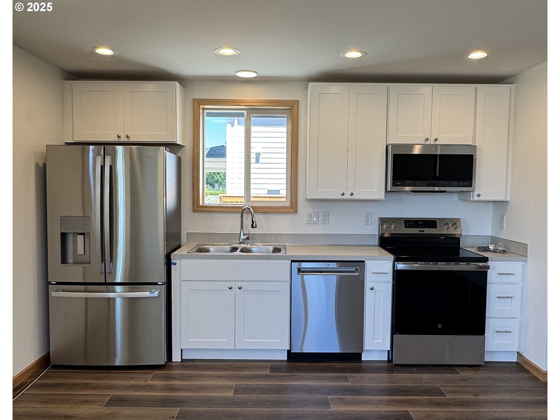 735 ST Charles Street Eugene, OR 97402 - Photo 5 of 30 a kitchen with stainless steel appliances granite countertop a stove a refrigerator a sink and a microwave