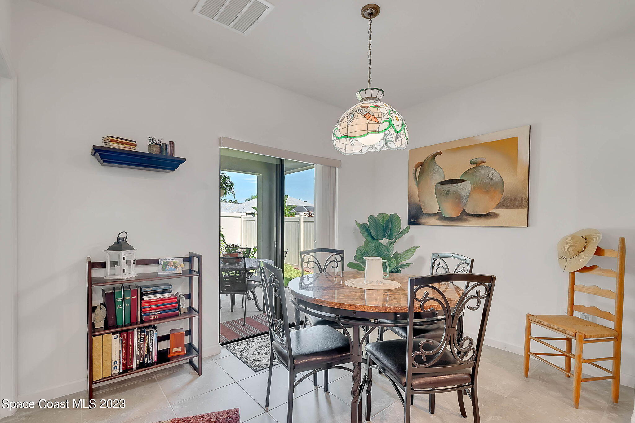 3536 Whimsical Circle Rockledge, FL 32955 - Photo 11 of 40 a view of a dining room with furniture a chandelier and wooden floor