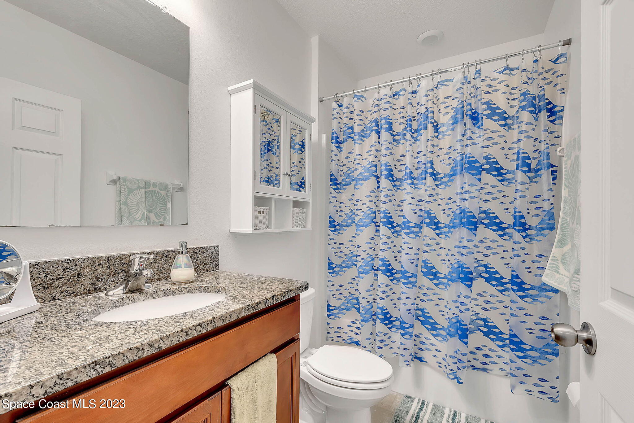 3536 Whimsical Circle Rockledge, FL 32955 - Photo 15 of 40 a bathroom with a granite countertop sink a toilet and a shower