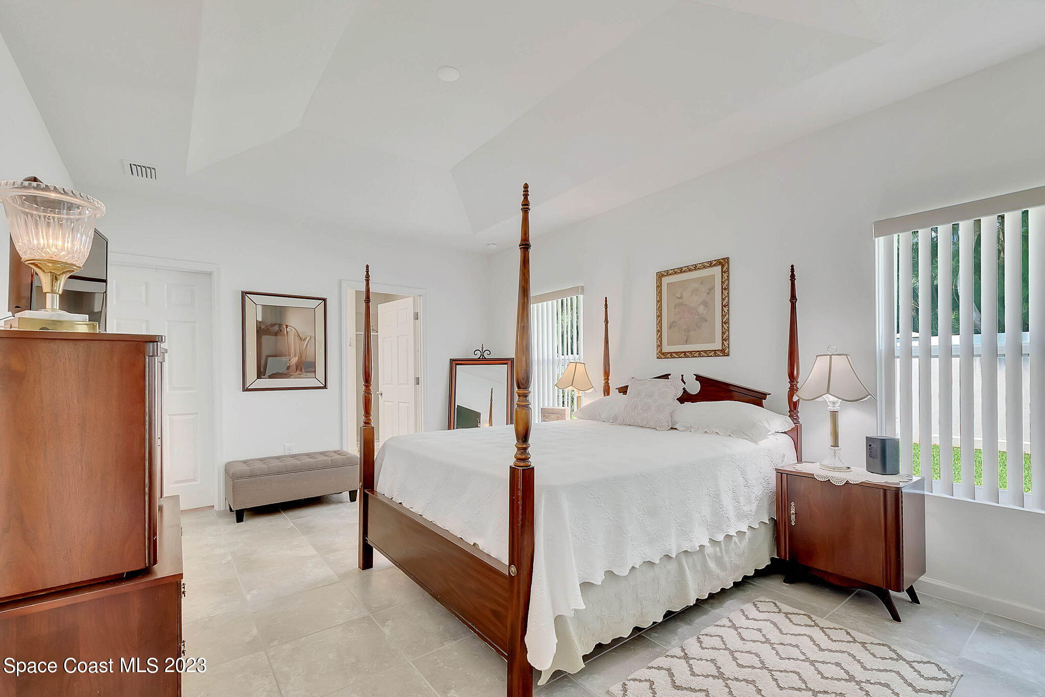 3536 Whimsical Circle Rockledge, FL 32955 - Photo 20 of 40 a bedroom with a bed lamp and a window