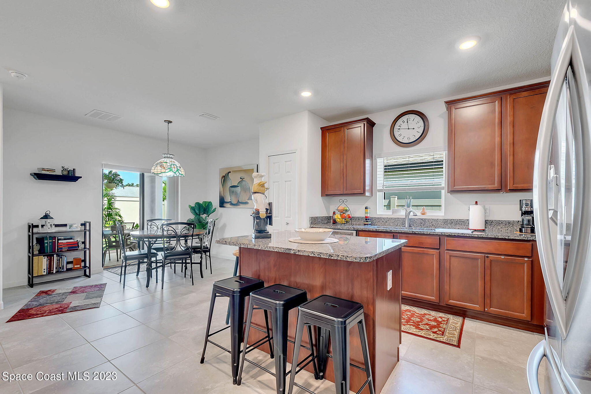 3536 Whimsical Circle Rockledge, FL 32955 - Photo 8 of 40 a kitchen with stainless steel appliances granite countertop dining table chairs cabinets and a window