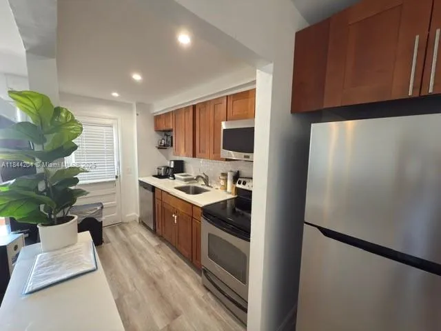 a kitchen with a refrigerator and a sink