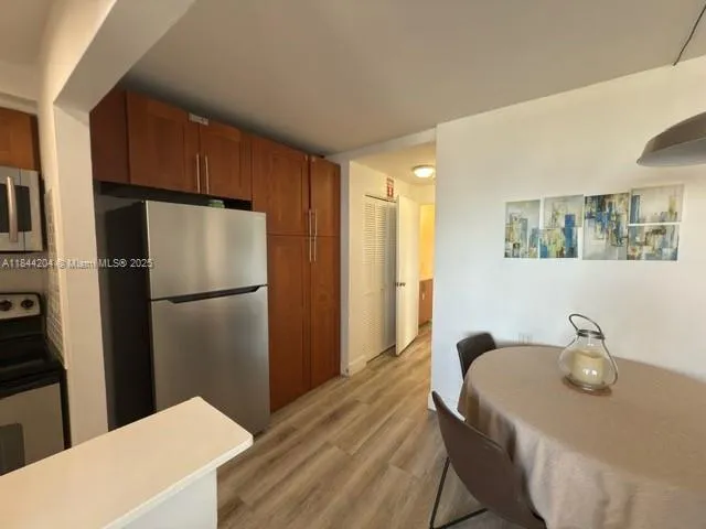 a kitchen with a refrigerator and a sink