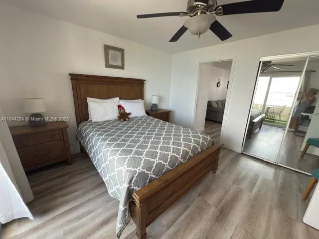 a bedroom with a large bed and next to a window