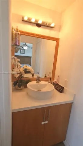 a bathroom with a granite countertop bathtub shower and toilet