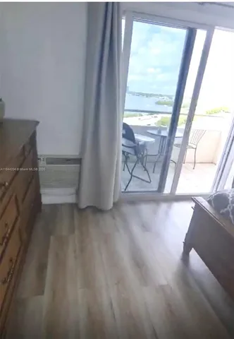 a view of a balcony with chair and wooden floor