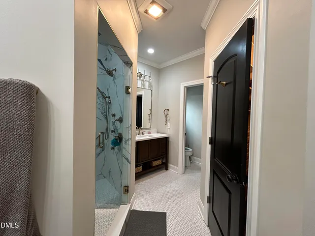 a bathroom with a double vanity sink and shower