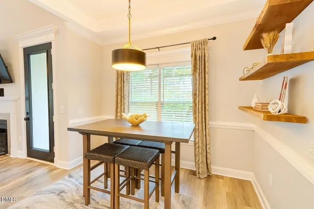 a view of a room with a table and chairs