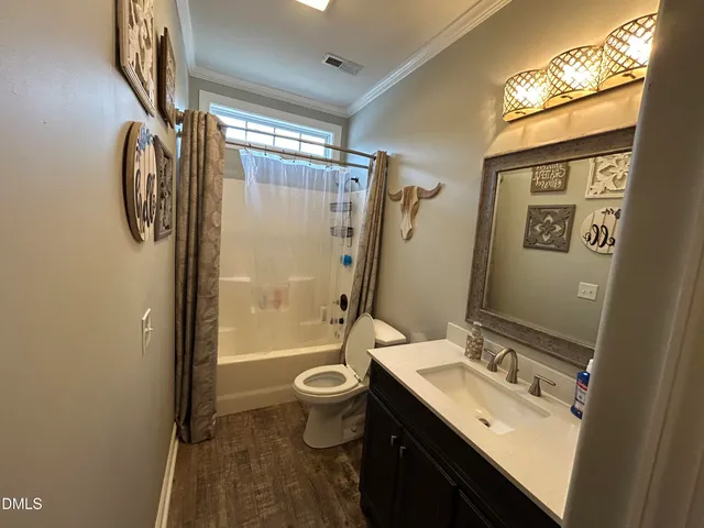 a bathroom with a sink mirror toilet and shower