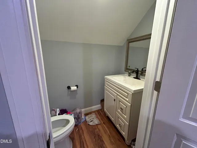 a bathroom with a sink toilet and a mirror
