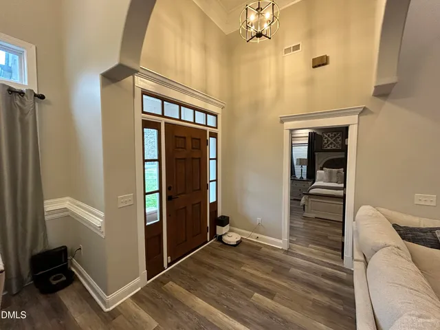 a view of a livingroom with wooden floor and staircase