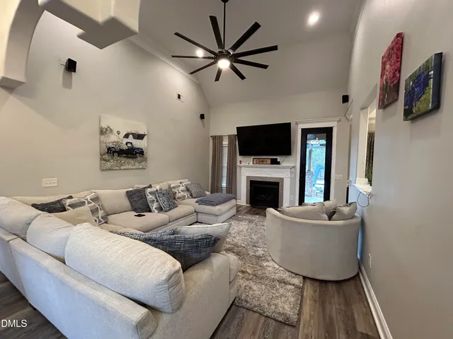 a living room with furniture a fireplace and a flat screen tv